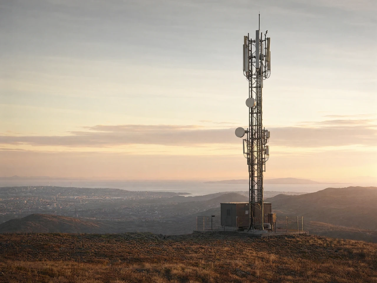 Illustrative telecommunications infrastructure on a coastal ridge.